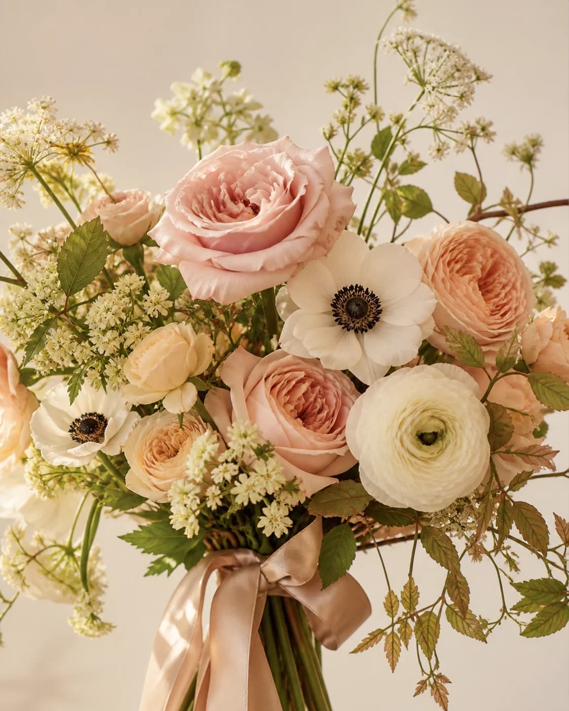 Close-up of blush roses, ranunculus and meadow flowers